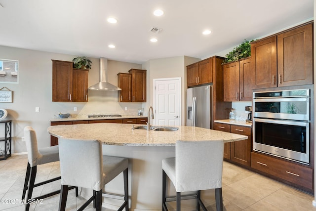 7084 W Cliff Spring Trl, Marana, AZ 85658 - kitchen with wall chimney exhaust hood, a sink, stainless steel appliances, a kitchen bar, and light tile patterned flooring