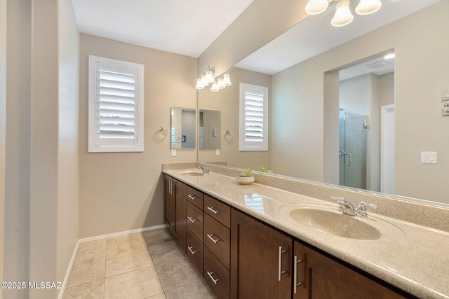 7084 W Cliff Spring Trl, Marana, AZ 85658 - bathroom with baseboards, double vanity, a shower stall, and tile patterned floors