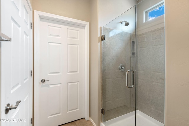 7084 W Cliff Spring Trl, Marana, AZ 85658 - bathroom featuring a shower stall, tile patterned floors, and baseboards