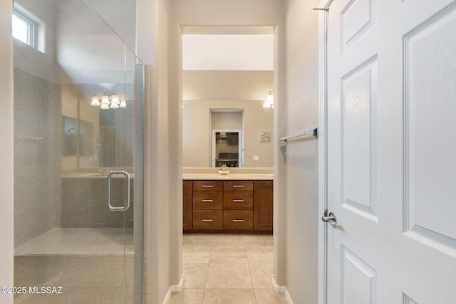 7084 W Cliff Spring Trl, Marana, AZ 85658 - full bathroom featuring a shower stall, tile patterned floors, vanity, and baseboards
