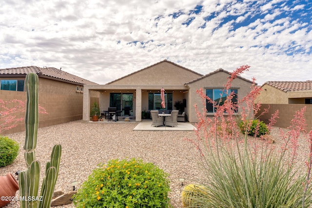 7084 W Cliff Spring Trl, Marana, AZ 85658 - rear view of house with stucco siding, fence, and a patio