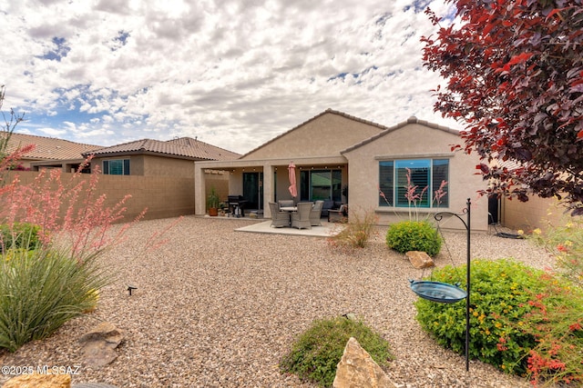 7084 W Cliff Spring Trl, Marana, AZ 85658 - rear view of house with stucco siding, fence, a tiled roof, and a patio area