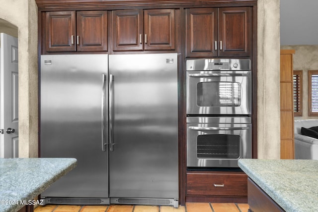 kitchen featuring appliances with stainless steel finishes and light tile patterned flooring
