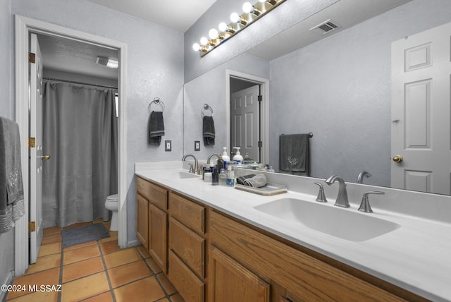 full bathroom with visible vents, a sink, tile patterned floors, and toilet