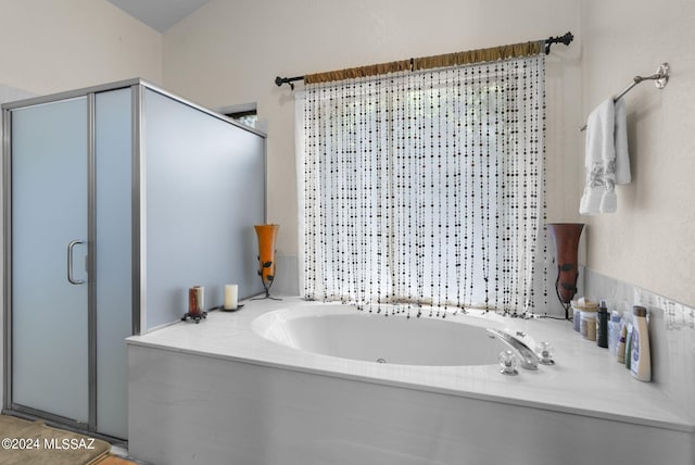 full bath featuring a whirlpool tub and a shower stall