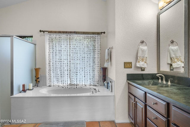 full bathroom with a garden tub, tile patterned flooring, and vanity