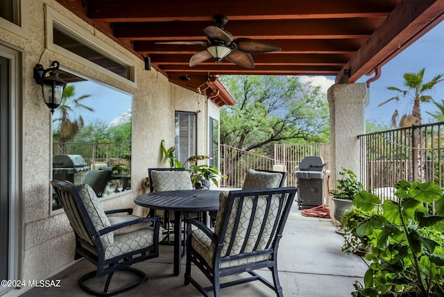 view of patio featuring fence, a ceiling fan, outdoor dining area, and a grill