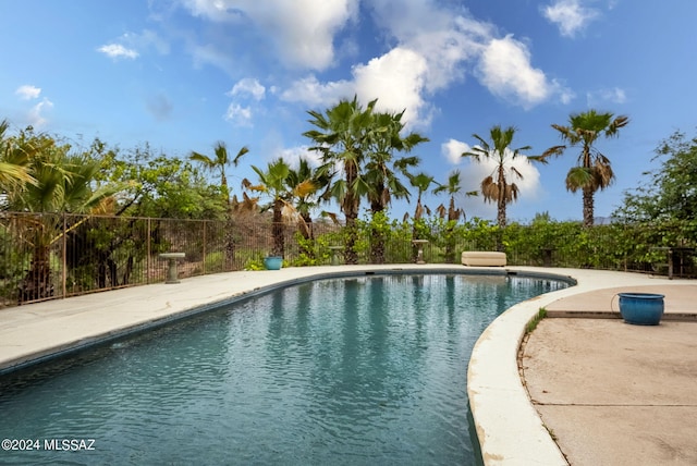 view of swimming pool with a fenced in pool, fence, and a patio