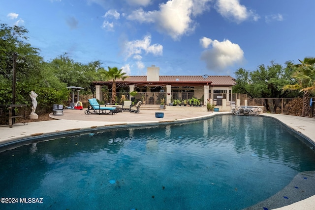 view of swimming pool featuring a fenced in pool, a patio area, and fence