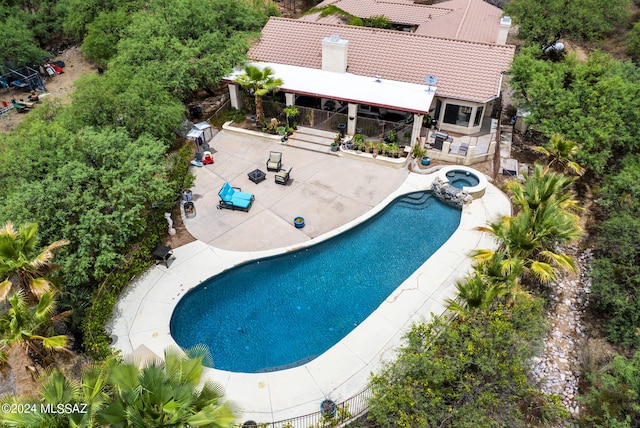 view of pool featuring a patio and a pool with connected hot tub