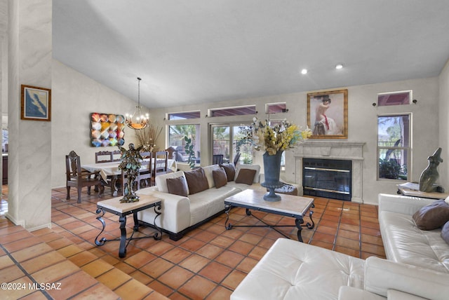 living area featuring an inviting chandelier, plenty of natural light, a fireplace, and lofted ceiling