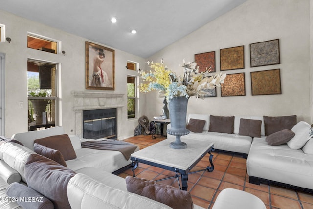 living room featuring a premium fireplace, tile patterned floors, plenty of natural light, and lofted ceiling