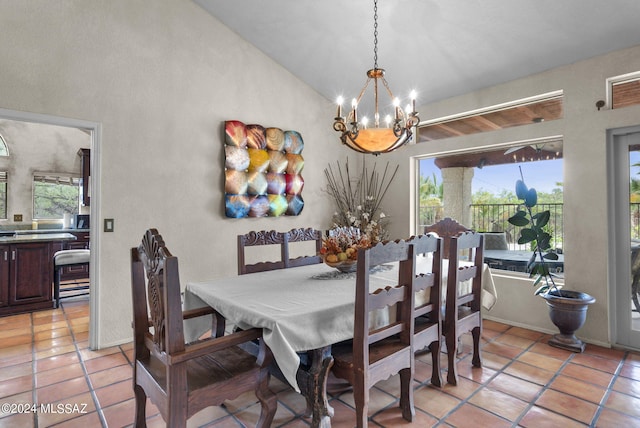 dining room featuring light tile patterned flooring, a notable chandelier, a healthy amount of sunlight, and lofted ceiling
