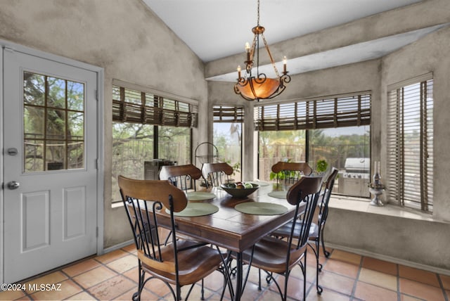 tiled dining room featuring vaulted ceiling