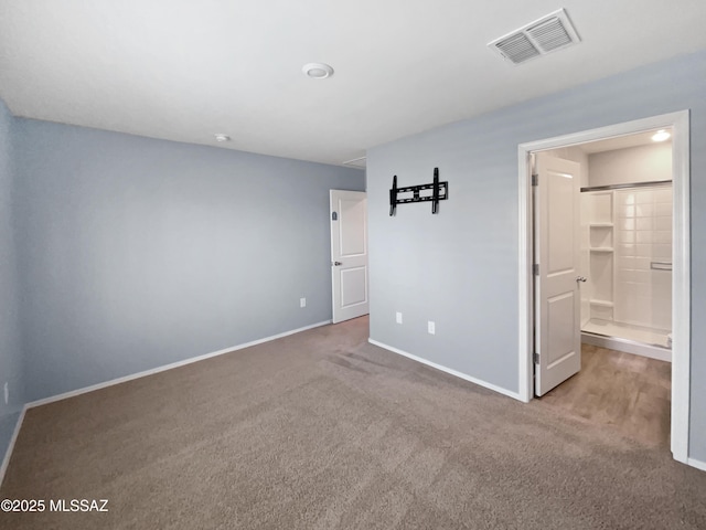 unfurnished bedroom featuring baseboards, carpet, and visible vents
