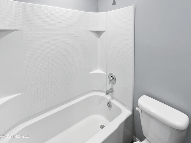 bathroom featuring shower / bathing tub combination and toilet