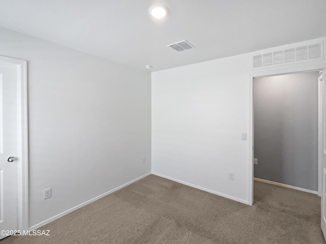 empty room with baseboards, carpet, and visible vents
