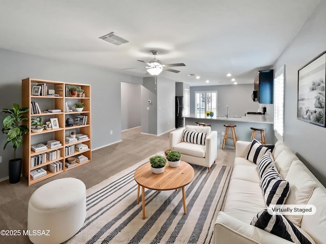 living room with light colored carpet, a ceiling fan, baseboards, recessed lighting, and visible vents