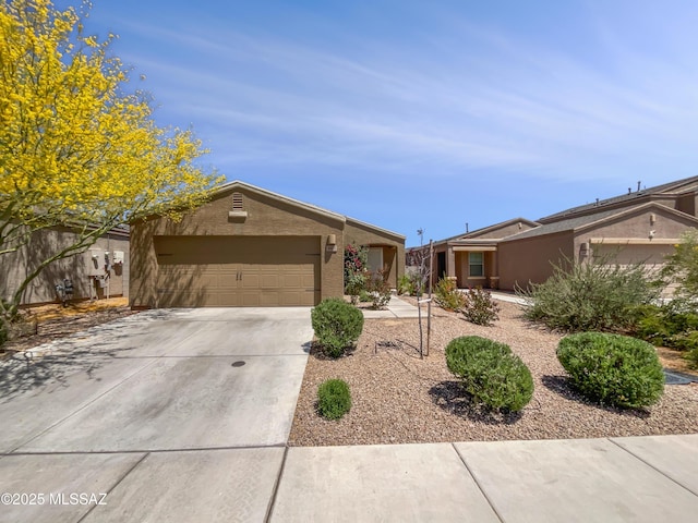 ranch-style home featuring concrete driveway, stucco siding, and a garage