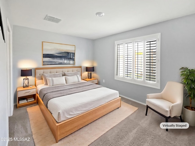 carpeted bedroom featuring visible vents and baseboards