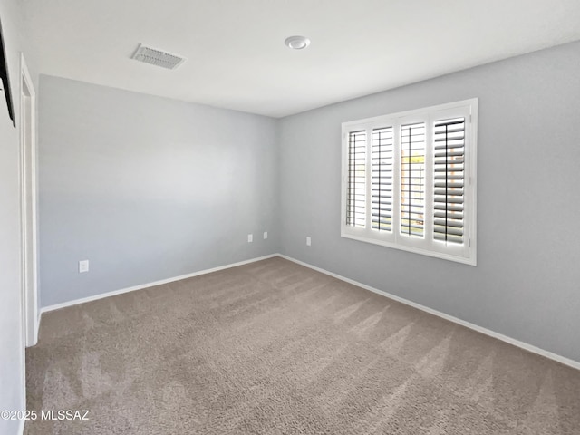 carpeted empty room with baseboards and visible vents
