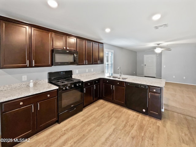 kitchen featuring ceiling fan, a sink, a peninsula, visible vents, and black appliances