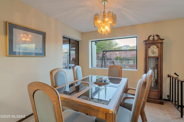 dining space featuring a textured ceiling and a notable chandelier