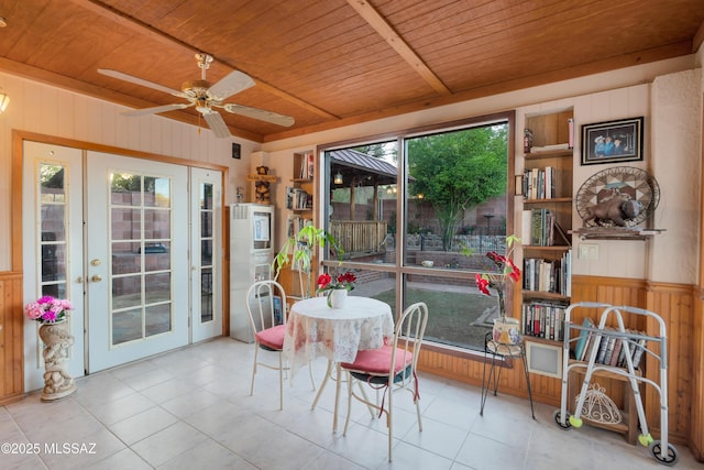 dining room with wood walls, ceiling fan, tile patterned floors, and wooden ceiling
