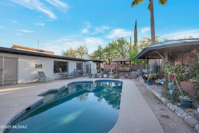 view of swimming pool featuring a fenced in pool, fence, a gazebo, and a patio area