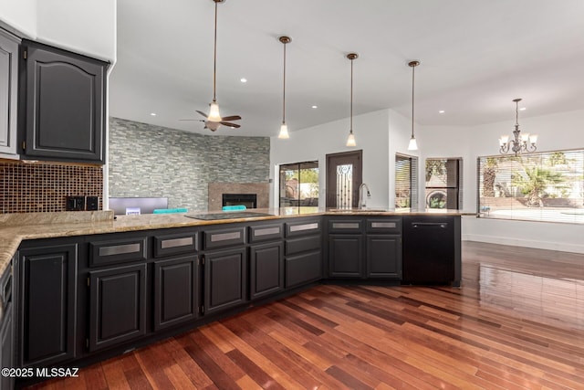 1330 W Panorama Rd, Tucson, AZ 85704 - kitchen with tasteful backsplash, a fireplace, dishwasher, a sink, and ceiling fan with notable chandelier