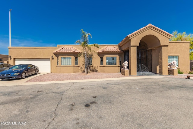 1330 W Panorama Rd, Tucson, AZ 85704 - view of front facade featuring stucco siding, an attached garage, driveway, and a tile roof