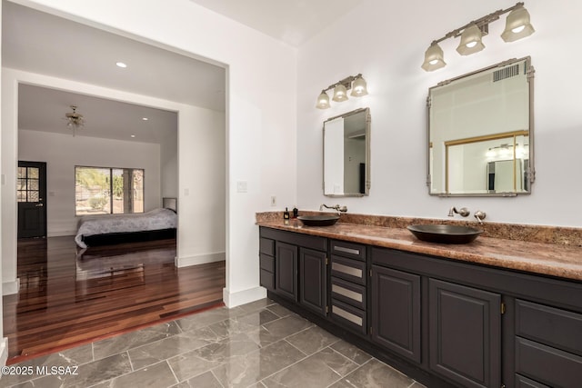 1330 W Panorama Rd, Tucson, AZ 85704 - ensuite bathroom featuring baseboards, a sink, marble finish floor, and double vanity