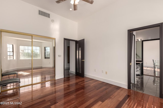 1330 W Panorama Rd, Tucson, AZ 85704 - unfurnished bedroom featuring baseboards, a high ceiling, visible vents, and wood finished floors