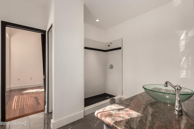1330 W Panorama Rd, Tucson, AZ 85704 - full bath with baseboards, a tile shower, and a sink