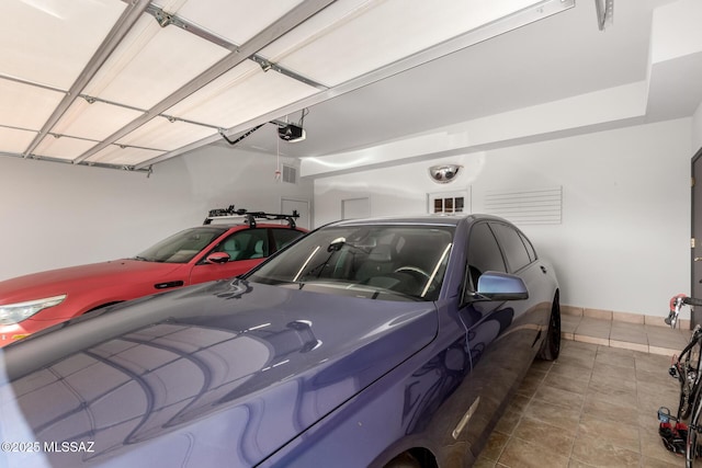 1330 W Panorama Rd, Tucson, AZ 85704 - garage with a garage door opener and visible vents