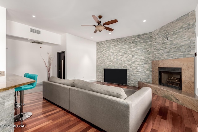 1330 W Panorama Rd, Tucson, AZ 85704 - living room featuring visible vents, a high end fireplace, a ceiling fan, and wood finished floors