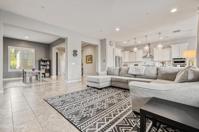 living area featuring recessed lighting, baseboards, visible vents, and light tile patterned floors
