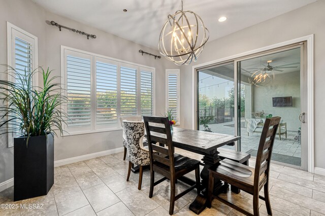 dining area featuring an inviting chandelier, baseboards, and plenty of natural light