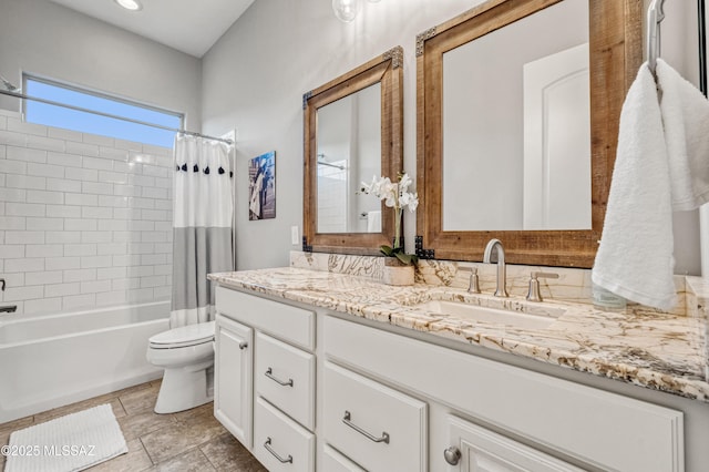 bathroom with vanity, shower / tub combo with curtain, and toilet