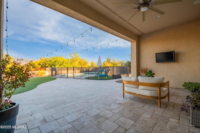 view of patio featuring a fenced backyard, a fenced in pool, and ceiling fan