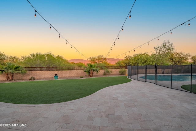exterior space featuring a fenced backyard, a pool, a lawn, and a patio