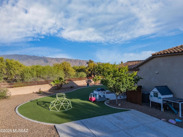 exterior space with a mountain view and fence