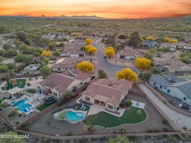 aerial view at dusk with a mountain view and a residential view