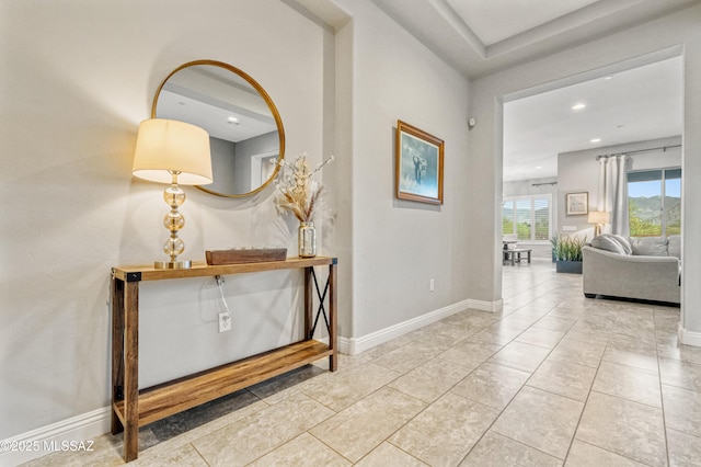 hallway featuring recessed lighting and baseboards
