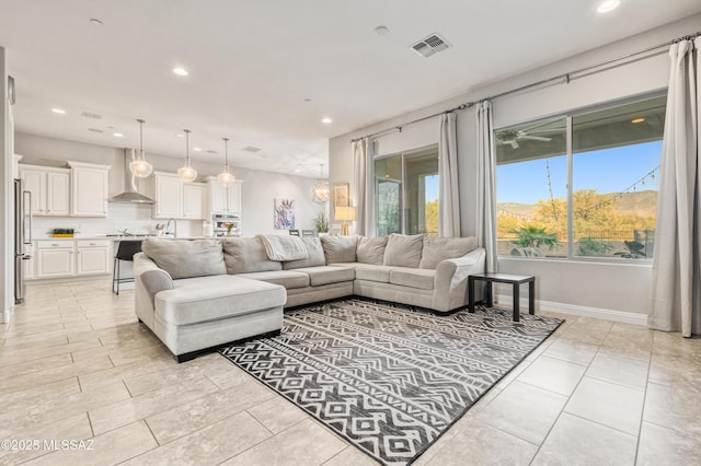 living room featuring ceiling fan, recessed lighting, baseboards, light tile patterned floors, and visible vents