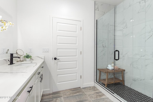 bathroom with vanity, marble finish floor, and a marble finish shower
