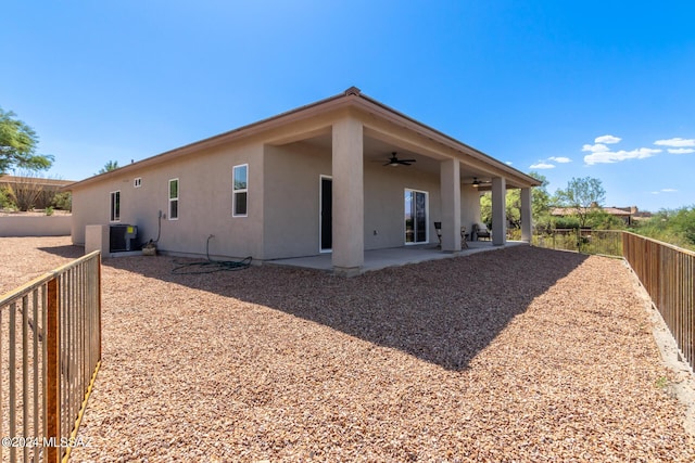 back of house with ceiling fan, a patio, a fenced backyard, stucco siding, and central air condition unit