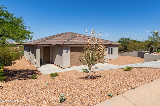 single story home with a garage and stucco siding