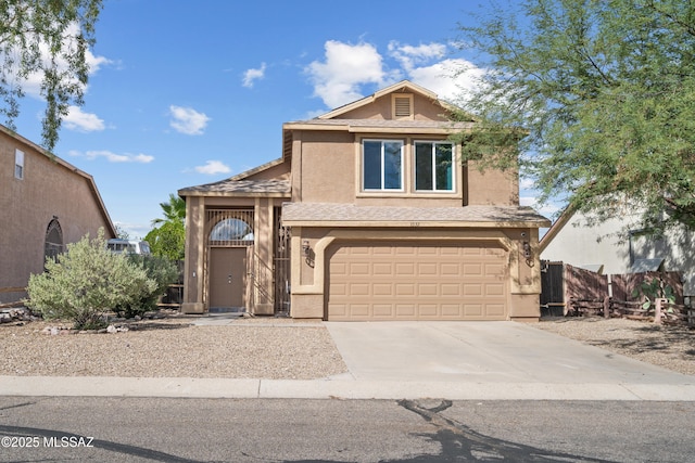 view of front of house with a garage, stucco siding, driveway, and fence