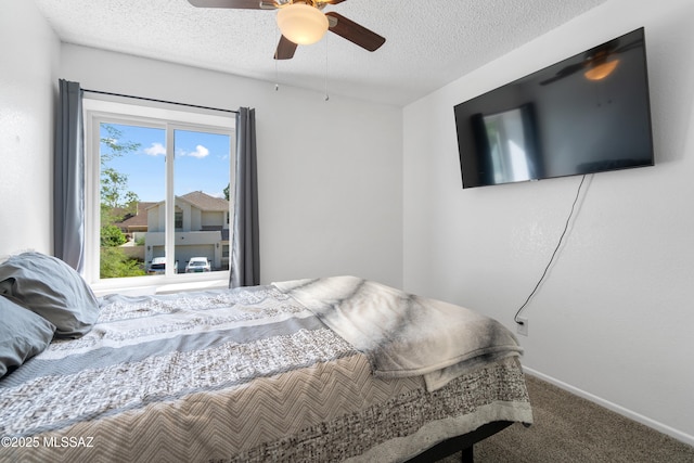 bedroom with baseboards, a textured ceiling, carpet, and ceiling fan